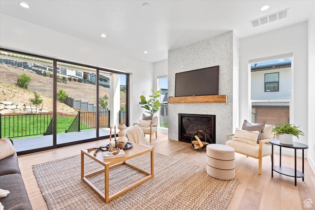 5554 N Fox Canyon Rd, Lehi, UT 84043 - living area with plenty of natural light, a fireplace, wood finished floors, and recessed lighting
