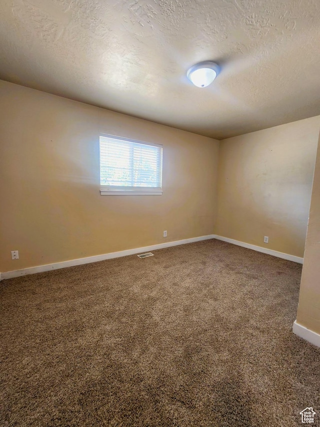 464 N Grant St, Salt Lake City, UT 84116 - carpeted empty room with a textured ceiling and baseboards