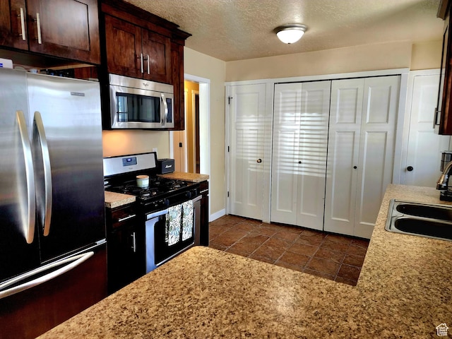 464 N Grant St, Salt Lake City, UT 84116 - kitchen featuring stainless steel appliances, dark brown cabinetry, and a textured ceiling