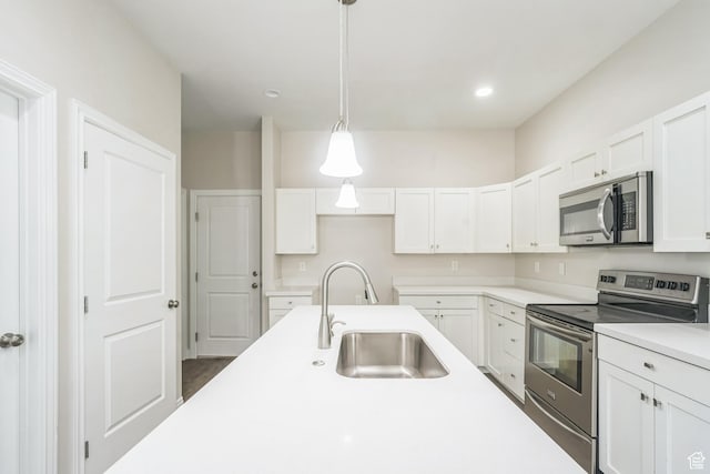 3872 S 1630 W, West Valley City, UT 84119 - kitchen featuring appliances with stainless steel finishes, white cabinetry, light countertops, pendant lighting, and recessed lighting