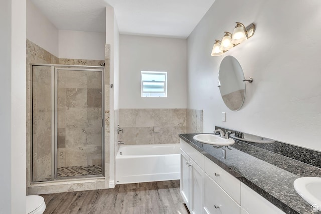 3872 S 1630 W, West Valley City, UT 84119 - bathroom featuring double vanity, a shower stall, a bath, and wood finished floors