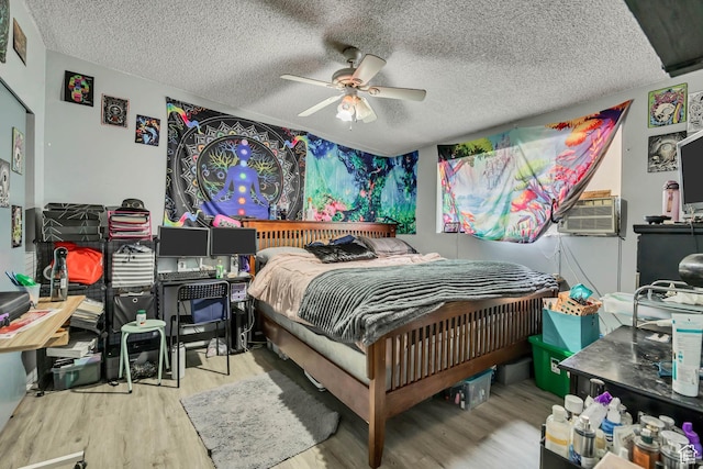 222 W Center St S, Midvale, UT 84047 - bedroom featuring wood finished floors, a textured ceiling, cooling unit, and ceiling fan