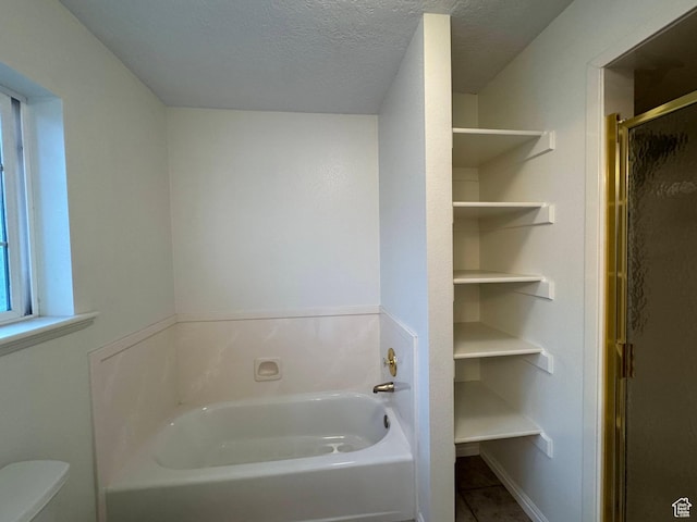 511 W 40 N, Orem, UT 84057 - bathroom featuring a bath, a shower stall, tile patterned floors, and a textured ceiling