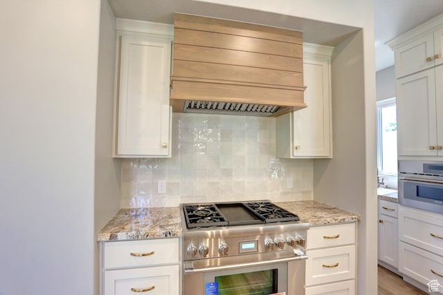 435 E Maple St, Mapleton, UT 84664 - kitchen featuring appliances with stainless steel finishes, custom exhaust hood, backsplash, white cabinetry, and light stone countertops