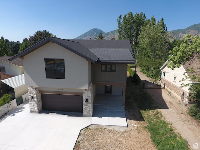 435 E Maple St, Mapleton, UT 84664 - view of front of house with a standing seam roof, a garage, concrete driveway, and a mountain view