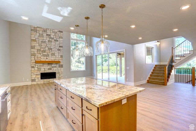 435 E Maple St, Mapleton, UT 84664 - kitchen with open floor plan, light wood-style floors, healthy amount of natural light, light stone countertops, and recessed lighting