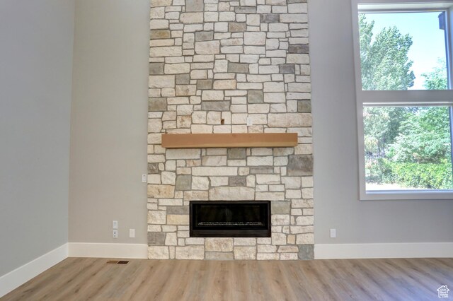 435 E Maple St, Mapleton, UT 84664 - detailed view of wood finished floors and a stone fireplace