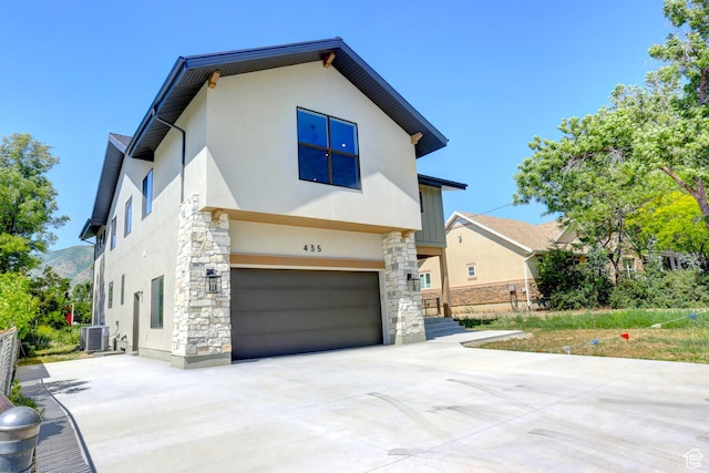 435 E Maple St, Mapleton, UT 84664 - view of front of house with stucco siding, stone siding, concrete driveway, and an attached garage
