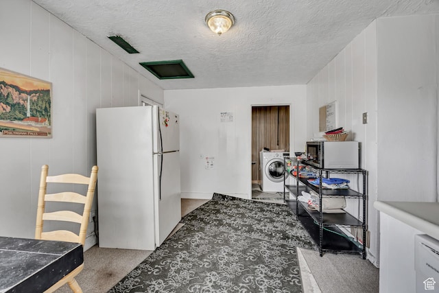 733 E Linden Ave, Salt Lake City, UT 84102 - kitchen featuring freestanding refrigerator, washer / clothes dryer, stainless steel microwave, carpet, and a textured ceiling