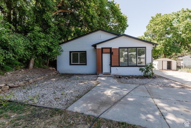 221 E 8th S, Ogden, UT 84401 - view of front of house featuring a shed, brick siding, and a patio
