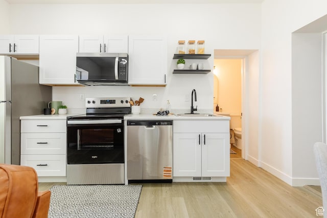 221 E 8th S, Ogden, UT 84401 - kitchen featuring stainless steel appliances, light wood-type flooring, and light countertops