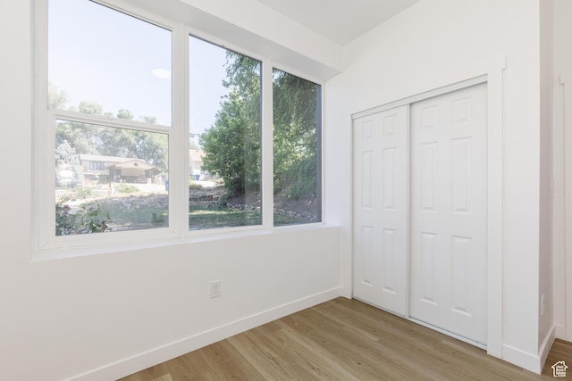 221 E 8th S, Ogden, UT 84401 - unfurnished bedroom featuring light wood finished floors and a closet