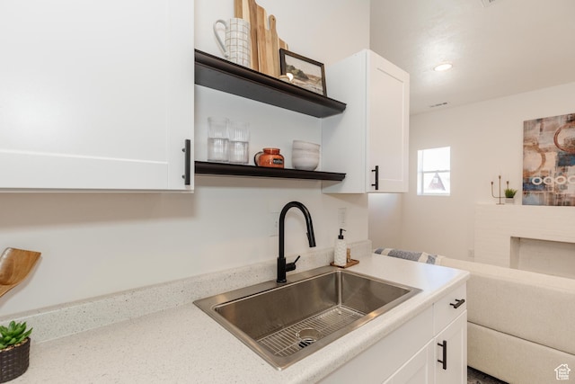 221 E 8th S, Ogden, UT 84401 - kitchen with open shelves, white cabinets, recessed lighting, and a fireplace