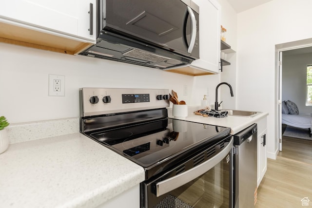 221 E 8th S, Ogden, UT 84401 - kitchen featuring stainless steel appliances, white cabinets, light wood finished floors, and open shelves