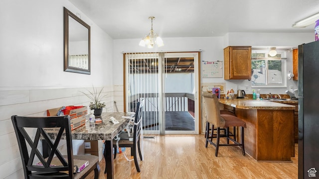 636 Downs Dr, Ogden, UT 84404 - dining space with light wood finished floors and a chandelier