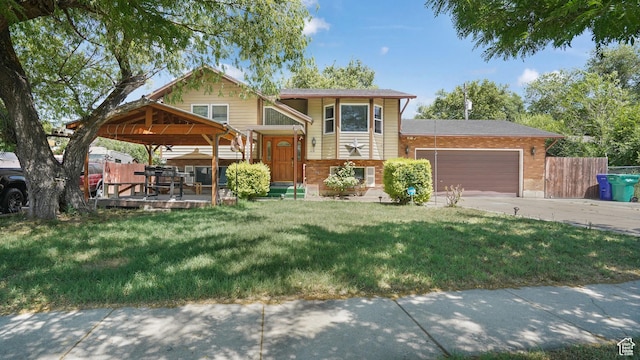 636 Downs Dr, Ogden, UT 84404 - view of front of home featuring brick siding, an attached garage, concrete driveway, and a gazebo