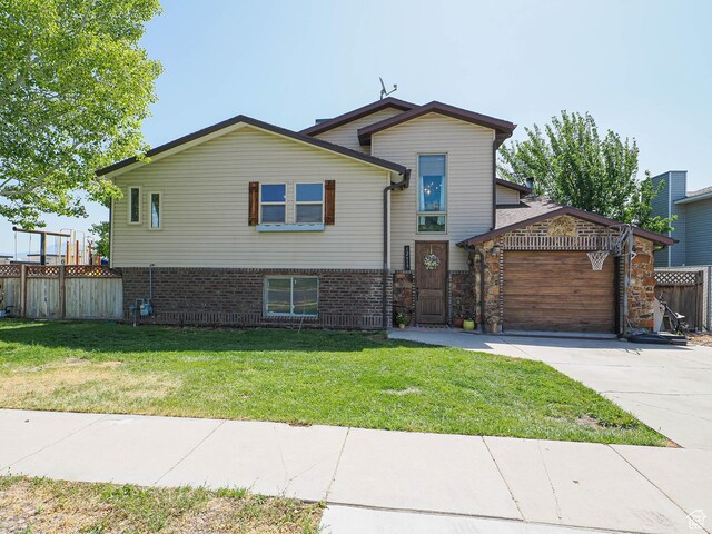 12615 S Dunhammer Dr, Riverton, UT 84065 - split level home featuring driveway, an attached garage, and brick siding