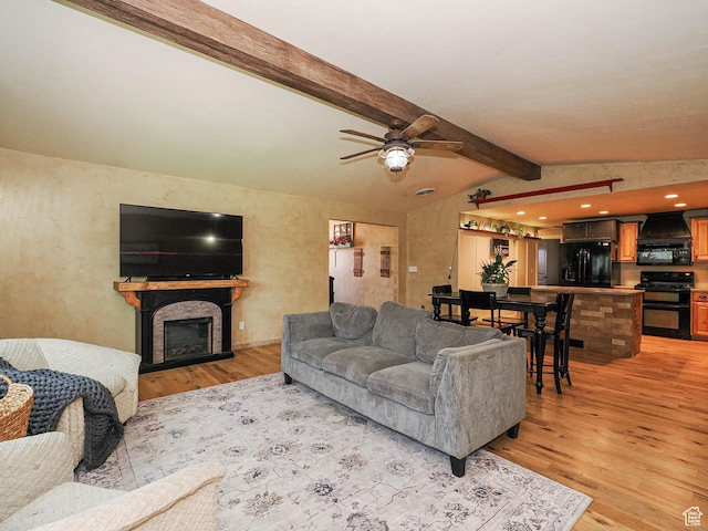 12615 S Dunhammer Dr, Riverton, UT 84065 - living area with light wood finished floors, ceiling fan, and a glass covered fireplace