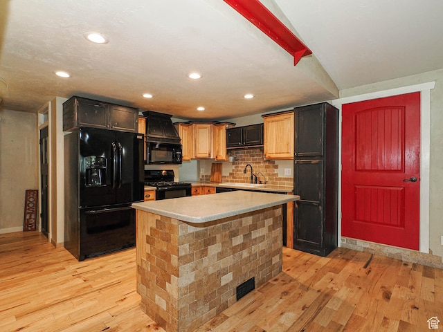 12615 S Dunhammer Dr, Riverton, UT 84065 - kitchen featuring black appliances, light wood finished floors, light countertops, backsplash, and a kitchen island
