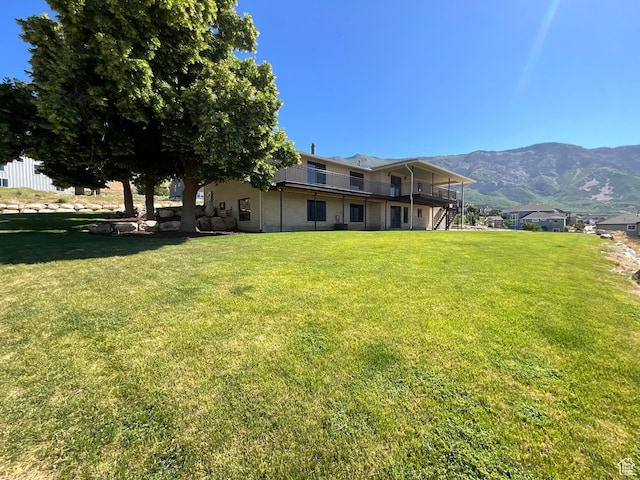 3696 N 475 E, North Ogden, UT 84414 - back of house featuring a lawn and a deck with mountain view