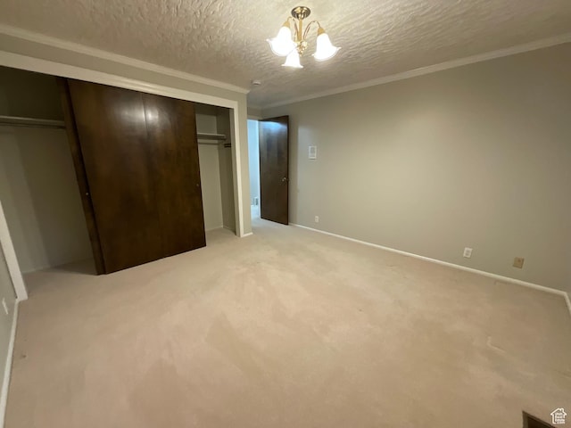 3696 N 475 E, North Ogden, UT 84414 - unfurnished bedroom featuring a textured ceiling, a chandelier, ornamental molding, light carpet, and a closet