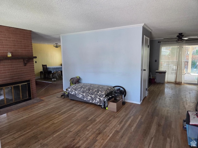 3947 W Ridgeview Way, Taylorsville, UT 84118 - bedroom with crown molding, wood finished floors, a textured ceiling, and a brick fireplace
