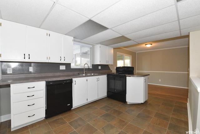 3947 W Ridgeview Way, Taylorsville, UT 84118 - kitchen featuring black appliances, a peninsula, dark countertops, white cabinets, and a paneled ceiling