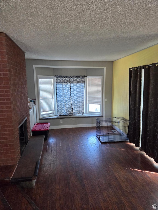 3947 W Ridgeview Way, Taylorsville, UT 84118 - unfurnished living room with hardwood / wood-style floors, a textured ceiling, a brick fireplace, and plenty of natural light