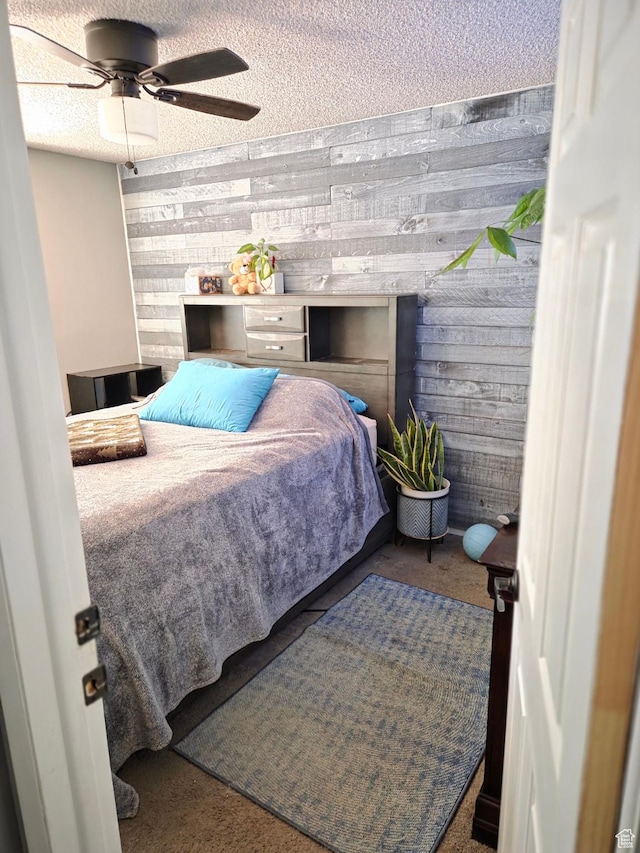 3947 W Ridgeview Way, Taylorsville, UT 84118 - carpeted bedroom featuring wood walls, a textured ceiling, and a ceiling fan