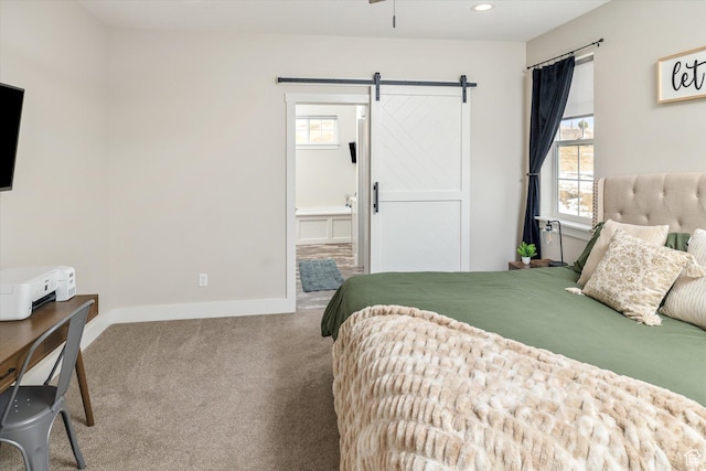 689 W Dee Dr, Garden City, UT 84028 - carpeted bedroom with a barn door, ensuite bath, and recessed lighting