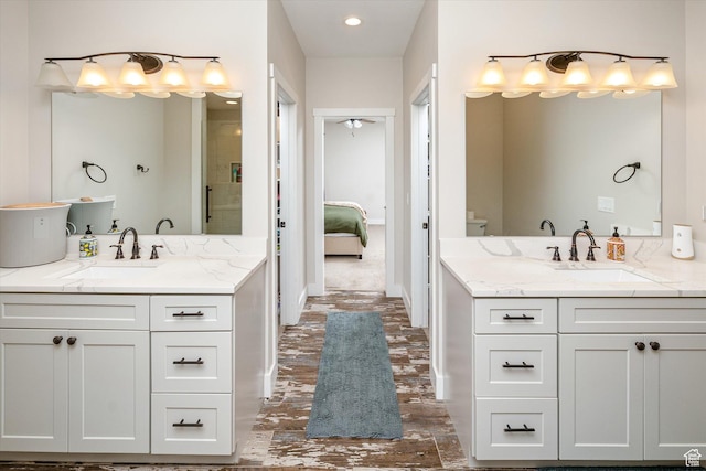689 W Dee Dr, Garden City, UT 84028 - bathroom with two vanities, connected bathroom, a shower, and recessed lighting