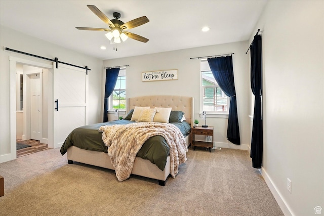 689 W Dee Dr, Garden City, UT 84028 - bedroom with carpet floors, a barn door, multiple windows, recessed lighting, and a ceiling fan
