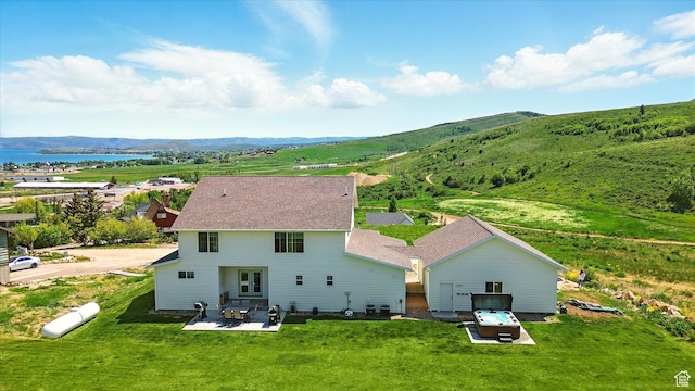 689 W Dee Dr, Garden City, UT 84028 - back of property with a water and mountain view, a patio, and a lawn