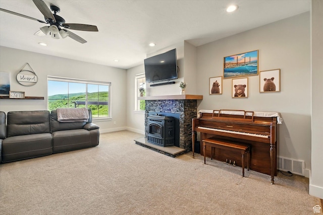 689 W Dee Dr, Garden City, UT 84028 - living room with carpet flooring, a wood stove, recessed lighting, and ceiling fan