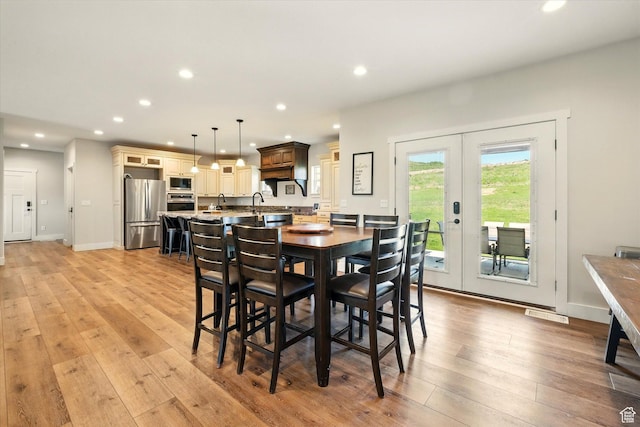 689 W Dee Dr, Garden City, UT 84028 - dining room featuring french doors, light wood-style flooring, and recessed lighting