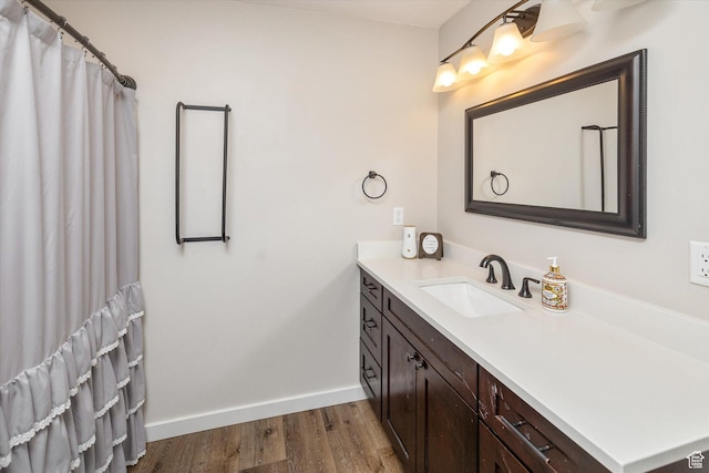 689 W Dee Dr, Garden City, UT 84028 - full bath with vanity, wood finished floors, and a shower with shower curtain