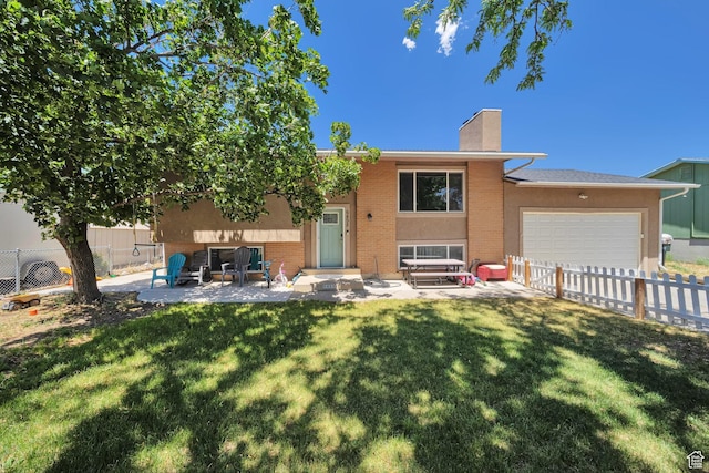 6498 W Castle View Dr S, West Valley City, UT 84128 - rear view of property with a chimney, an attached garage, brick siding, and a patio