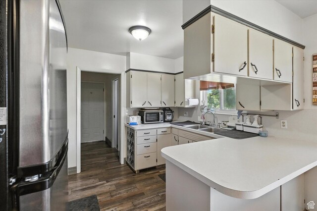 572 W 300 N, Hyrum, UT 84319 - kitchen with freestanding refrigerator, light countertops, dark wood-style floors, a peninsula, and stainless steel microwave