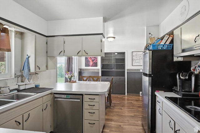 572 W 300 N, Hyrum, UT 84319 - kitchen featuring stainless steel dishwasher, black electric cooktop, a peninsula, dark wood finished floors, and light countertops