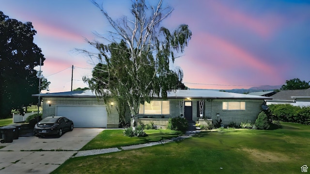 572 W 300 N, Hyrum, UT 84319 - ranch-style house featuring brick siding, an attached garage, driveway, and a front yard