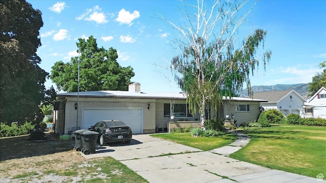 572 W 300 N, Hyrum, UT 84319 - ranch-style home with brick siding, driveway, an attached garage, a front yard, and a chimney