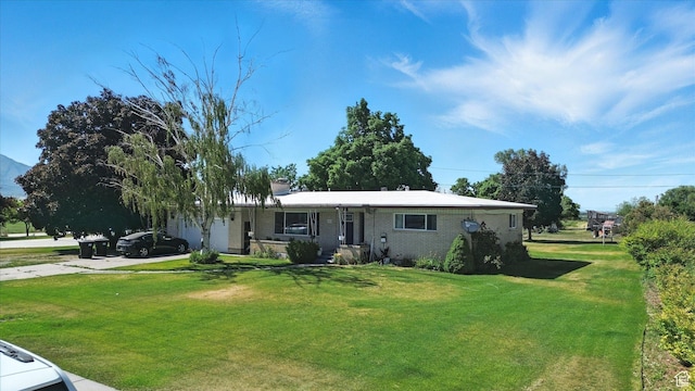 572 W 300 N, Hyrum, UT 84319 - view of front of home featuring driveway, brick siding, and a front lawn