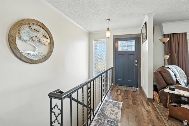 572 W 300 N, Hyrum, UT 84319 - foyer entrance with hardwood / wood-style floors, a textured ceiling, and ornamental molding