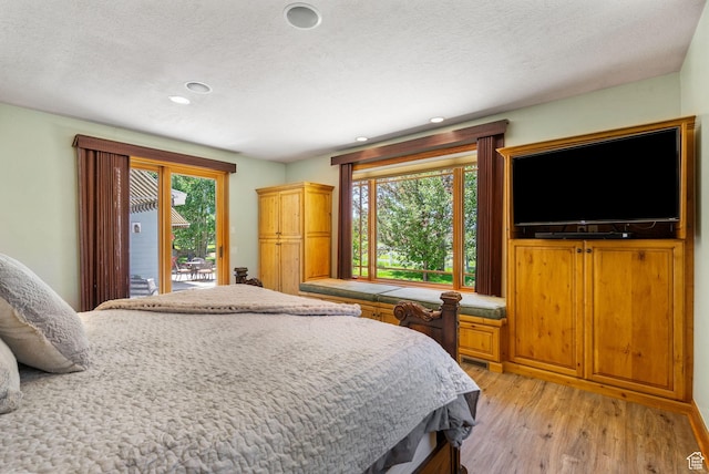 2125 E Elk Meadow Cir, Kamas, UT 84036 - bedroom with access to outside, light wood-type flooring, a textured ceiling, and recessed lighting