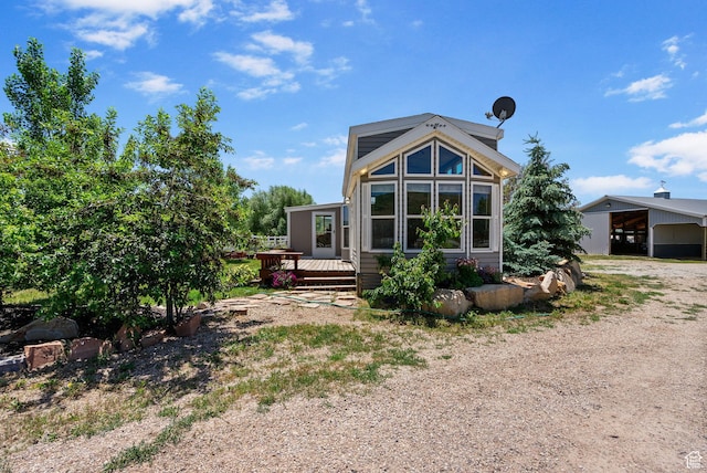 2125 E Elk Meadow Cir, Kamas, UT 84036 - rear view of house featuring dirt driveway, a deck, and a carport