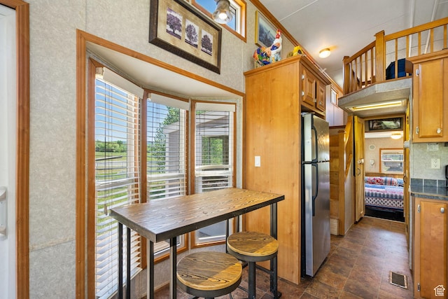 2125 E Elk Meadow Cir, Kamas, UT 84036 - kitchen featuring freestanding refrigerator, dark countertops, stone finish flooring, and brown cabinets