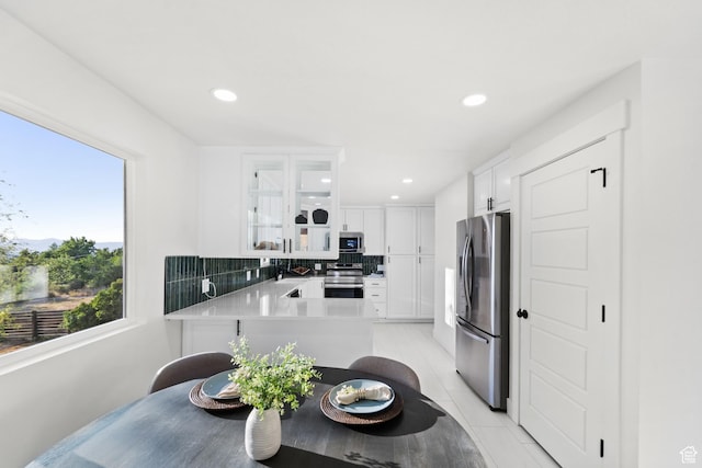 10 S 1400 E, Pleasant Grove, UT 84062 - kitchen featuring stainless steel appliances, glass insert cabinets, backsplash, white cabinets, and light countertops