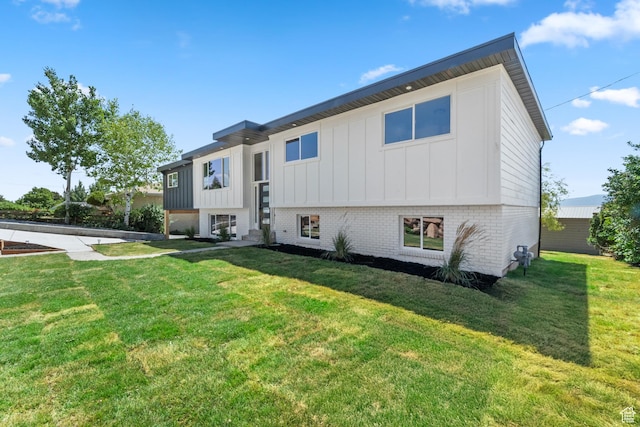 10 S 1400 E, Pleasant Grove, UT 84062 - back of property with board and batten siding, a yard, and brick siding