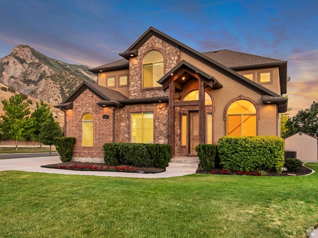 4067 W View Pointe Dr N, Highland, UT 84003 - view of front of home with a yard, stone siding, roof with shingles, and stucco siding