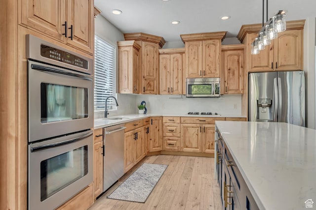 4067 W View Pointe Dr N, Highland, UT 84003 - kitchen with appliances with stainless steel finishes, light brown cabinets, light wood-style flooring, pendant lighting, and recessed lighting